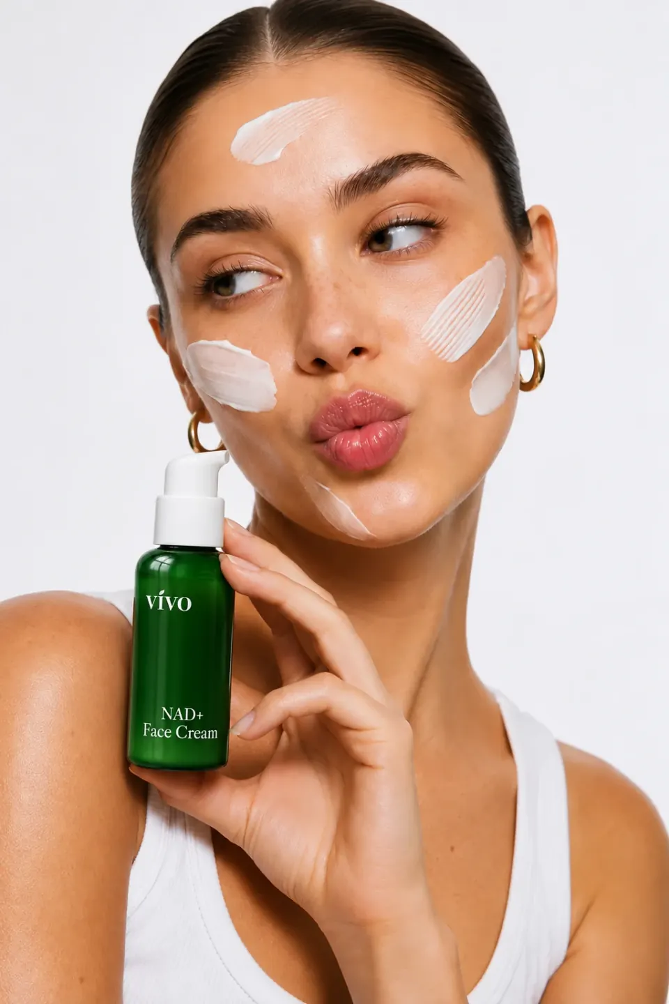 Woman holding a Vivo NAD+ Face Cream pump bottle