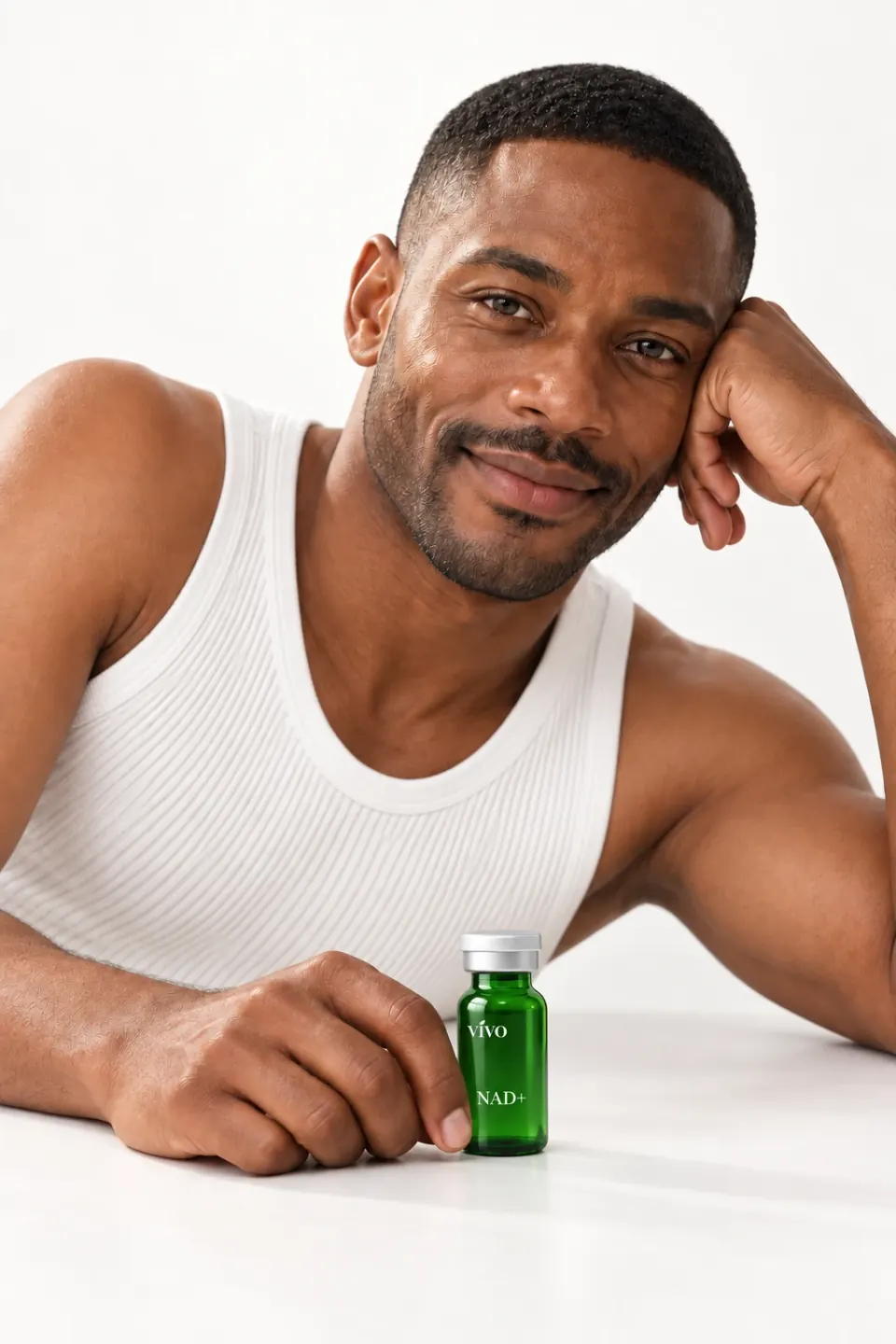 Man in a white tank top leaning on a table beside a Vivo NAD+ vial